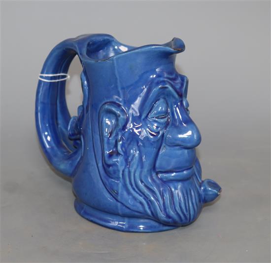 A C.H. Brannam blue glazed double mask jug, height 15cm